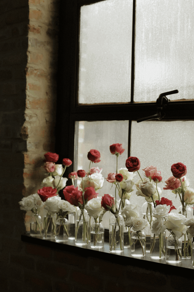 Romantic Valentine’s Day wedding florals against the stained glass windows